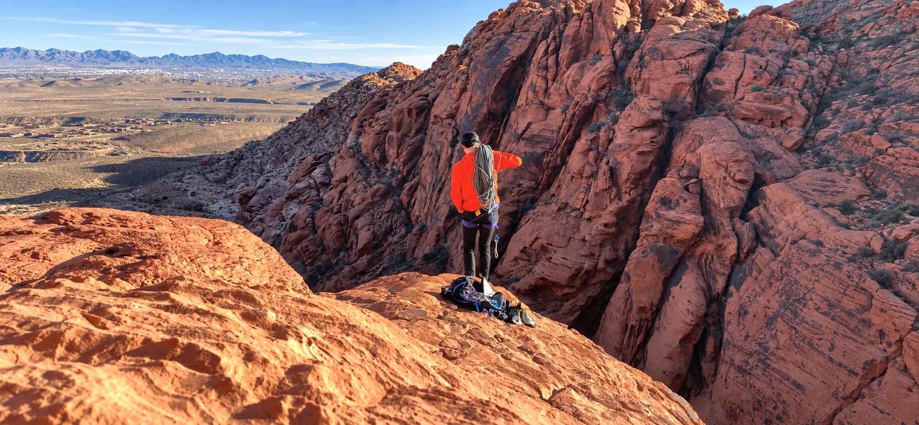A climber overlooking the sandstone cliffs of Red Rock Canyon, Nevada